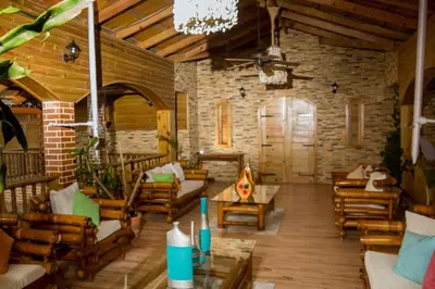 a large living room with wooden furniture and a chandelier at Spectacular Country Villa in Pedro Brand