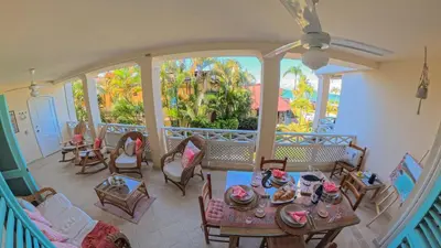 a living room with a table and chairs and a large window at La Dolce Vita Beachfront Apt 9 in Las Terrenas