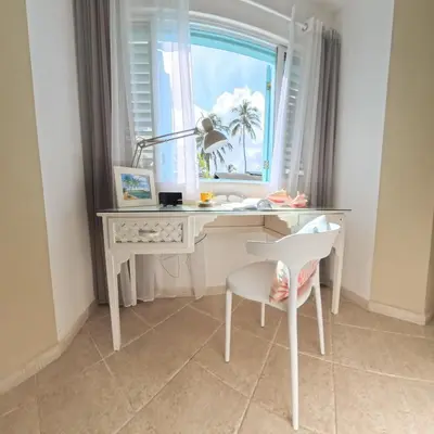 a desk with a window and a chair in a room at La Dolce Vita Beachfront Apt 9 in Las Terrenas