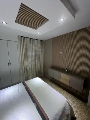 a bedroom with a large bed and a window at Comfortable apartment in Santo Domingo
