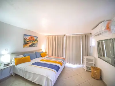 a bedroom with a large bed and a window at Central 1BR APT - 1 minute Walking from Rumba in Sosúa