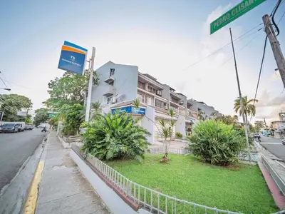 a street sign in front of a building at Central 1BR APT - 1 minute Walking from Rumba in Sosúa