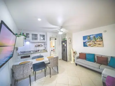 a kitchen and living room with a couch and a table at Central 1BR APT - 1 minute Walking from Rumba in Sosúa