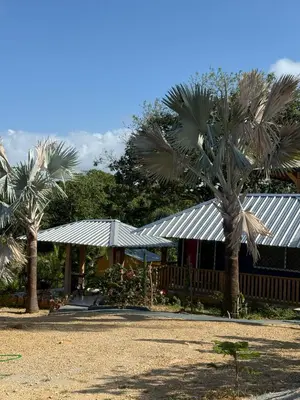 a building with palm trees in front of it at Villas Gabriel in Nagua