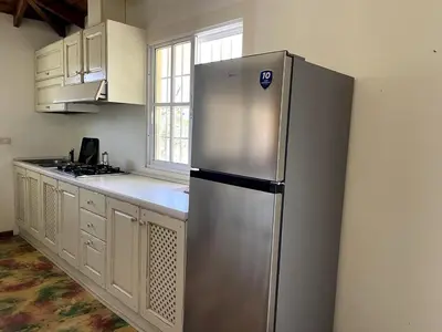 a stainless steel refrigerator in a kitchen with a window at Chalet Larimar Charming villa in Las Galeras in Las Galeras