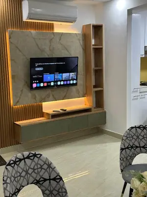 a living room with a flat screen tv on a wall at mamajuana House in Las Terrenas
