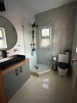 a bathroom with a shower and a toilet and a sink at mamajuana House in Las Terrenas