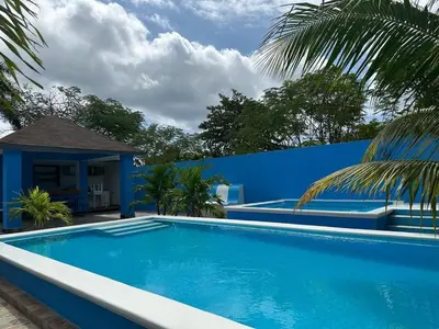 a blue swimming pool in front of a blue wall at Apartamento Costero 3 en Las Galeras de Samaná in Las Galeras
