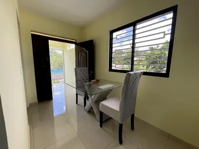 a dining room with a glass table and chairs at Apartamento Costero 3 en Las Galeras de Samaná in Las Galeras