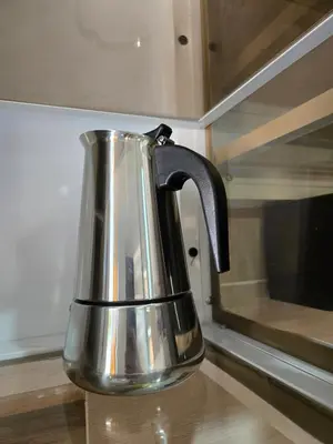 a silver tea kettle sitting on a counter next to a microwave at Casa Madome in Pedernales