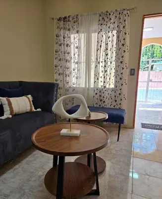a living room with a table and a couch at Casa Madome in Pedernales