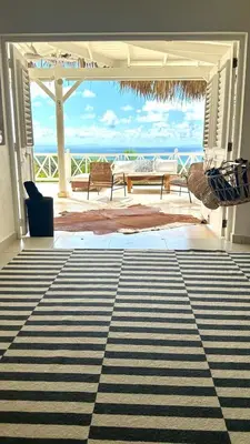 a living room with a view of the ocean at Villa blanca chambre d'hôtes vue sur mer in Las Terrenas