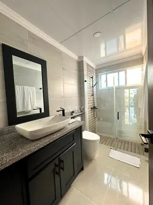 a bathroom with a sink and a toilet and a mirror at Eden Caribe Condo, Bavaro Punta Cana in Punta Cana