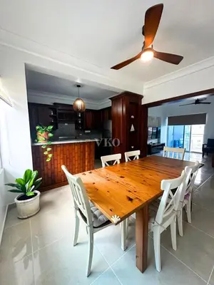 a dining room table with white chairs and a ceiling fan at Eden Caribe Condo, Bavaro Punta Cana in Punta Cana