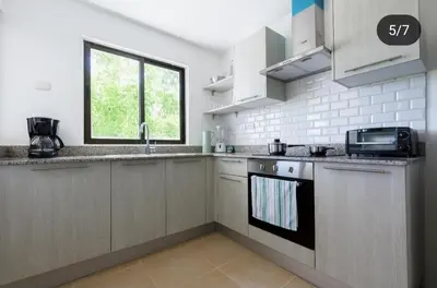 a kitchen with a sink and a stove top oven at Suite tropical in Punta Cana