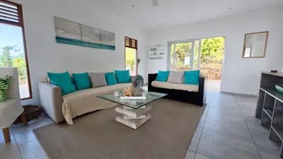 a living room with a couch and a table at The Nest, a quiet refuge with impressive views in Las Terrenas