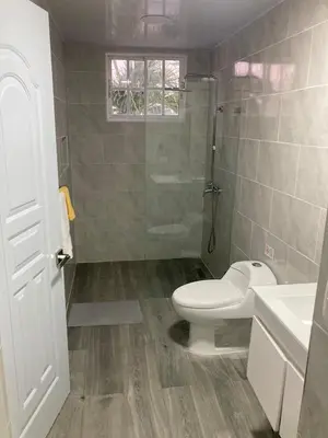 a bathroom with a toilet and a glass shower at Luxury Beach flat in Bávaro Puntacana! in Punta Cana