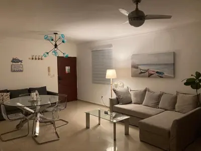 a living room with a couch and a table at Luxury Beach flat in Bávaro Puntacana! in Punta Cana