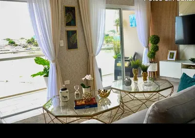a living room with two glass tables in front of a window at Modern Colonial Water View in Calero