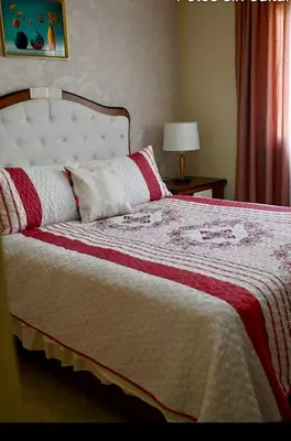 a bedroom with a bed with a red and white blanket at Modern Colonial Water View in Calero