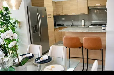 a kitchen with a glass table and a stainless steel refrigerator at Modern Colonial Water View in Calero