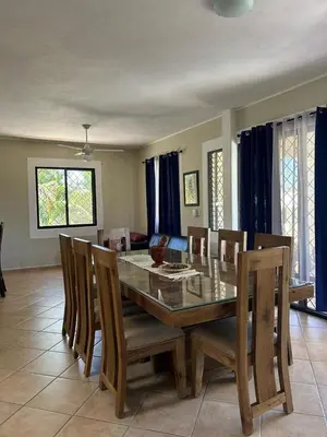 a dining room with a glass table and chairs at CASA Angelo in Sosúa