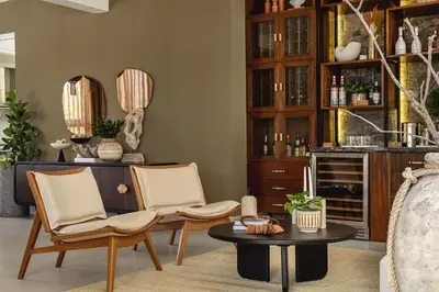 a living room with two chairs and a table at Villa Barbara, serviced accommodation in the heart of Puntarena beach club in Sabana Buey