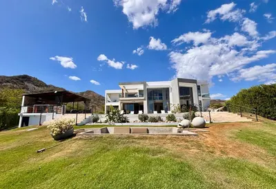 a large white house with a large yard at Villa Barbara, serviced accommodation in the heart of Puntarena beach club in Sabana Buey