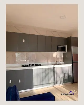 a kitchen with gray cabinets and a white counter top at apartment for rent in Bayahibe