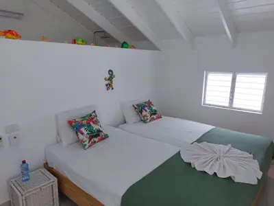 two twin beds in a room with white walls at Canela House 3BR Near to the beach in Las Terrenas