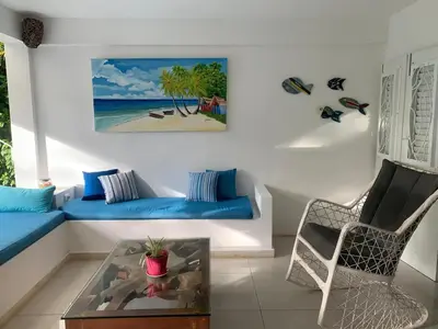 a living room with a blue couch and a chair at Canela House 3BR Near to the beach in Las Terrenas