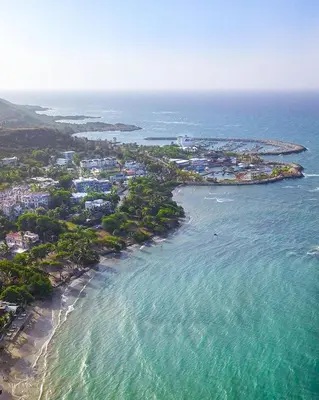an aerial view of a beach with houses and the ocean at Cofresi Villas in Maggiolo