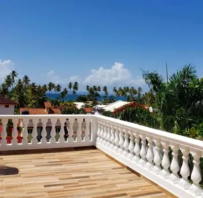 a white railing on a balcony with a view of the ocean at Lunamare Residence in Los Grini