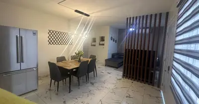 a kitchen and dining room with a table and chairs at Los laureles in Puerto Plata