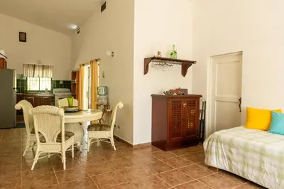 a room with a table and chairs and a bedroom at Playa Grande House in Las Galeras