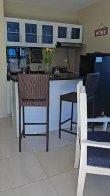a kitchen with a counter with chairs and a table at Sweet Home in Monte Llano