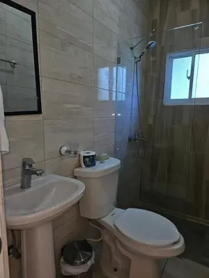 a bathroom with a toilet and a sink and a shower at Sweet Home in Monte Llano