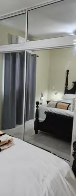 a bedroom with a reflection of a bed in a mirror at Sweet Home in Monte Llano