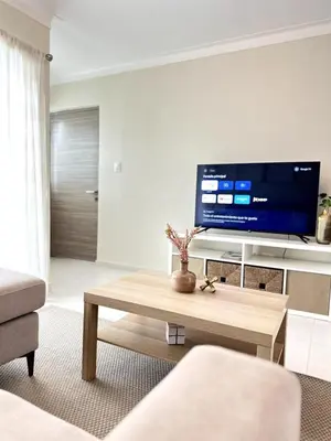 a living room with a tv and a coffee table at Belive 01 Condo in Santiago, the heart of the city in Santiago de los Caballeros
