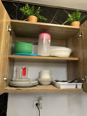 a kitchen cabinet with plates and bowls and dishes at Sweet dreams Tropical paradise in San Isidro