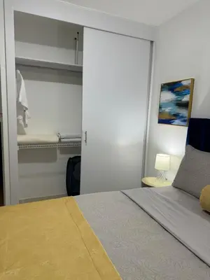 a bedroom with a bed with a sliding glass door at Sweet dreams Tropical paradise in San Isidro