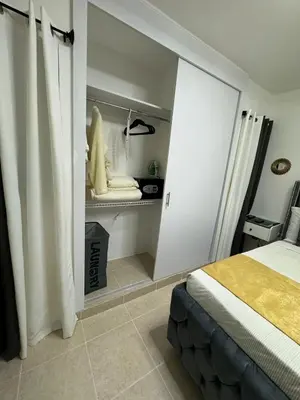 a white bedroom with a bed and a room with at Sweet dreams Tropical paradise in San Isidro