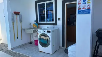 a washing machine in a bathroom with a sink at Villa Tropical Paradise Pool Rooftop in San Felipe de Puerto Plata