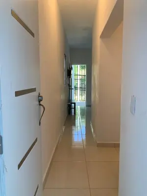 a hallway with white doors and a tile floor at Acogedor apartamento de 1 dormitorio cerca de la playa in Sosúa