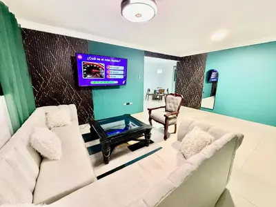 a living room with a couch and a tv on a wall at corales apartamento lll in La Viva