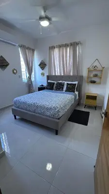 a bedroom with a bed in a white room at Villa Tropical Paradise Pool Rooftop in San Felipe de Puerto Plata