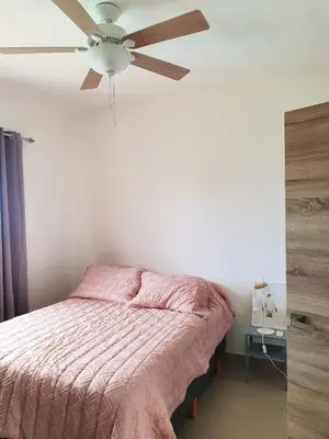 a bedroom with a ceiling fan and a bed at Apartment w private terrace and Jacuzzi in Las Terrenas