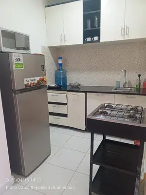 a kitchen with a refrigerator and a stove at Cerca de la playa apartamento familiar in Punta Cana