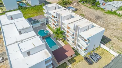 an aerial view of a white apartment building at Cozy 2BR Apartment in Sunshine Bayahibe in San Rafael del Yuma