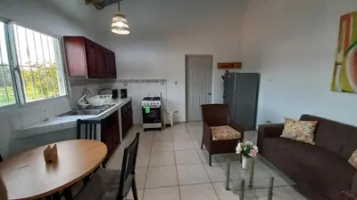 a kitchen and living room with a couch and a table at Apartamento de 2 habitaciones in Colorado